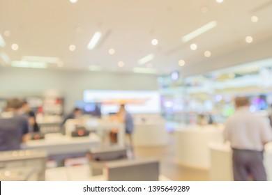 Mobile Phone In Electronic Store Interior With Customer Abstract Blurred Background