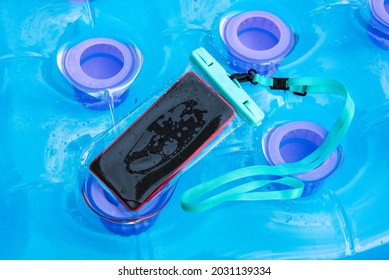 Mobile Phone Encased In A Clear Plastic Waterproof Case For Protection Against Water And Moisture In Summer While Enjoying Water Sports Outdoors