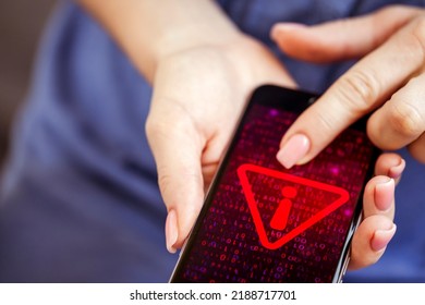 Mobile Phone In Female Hands With Screen Showing Compromised Virus Infected Device. Cyber Attack.