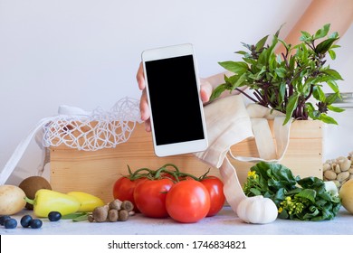 Mobile Phone With Fresh Vegetable In The Wood Box. Online Grocery And Organic Farmer Product Shopping Application. Food And Cooking Recipe Or Nutrition Counting.flat Lay.