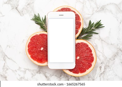 Mobile Phone And Grapefruits With Rosemary On Marble Background, Fruit And Technology Flatlay, Summer Minimal Compositon