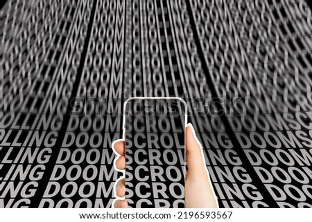 Mobile phone in hand against the background of an endless scroll of words - doomscrolling. Screen dependency disorder