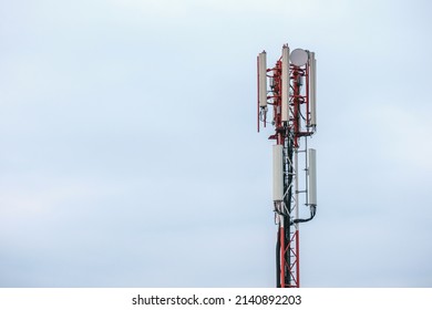 Mobile phone and internet cell tower over against sky. 5G wireless radiation antennas.
