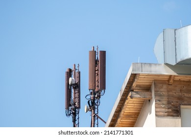 Mobile phone and internet cell tower over against sky. 5G wireless radiation antennas.