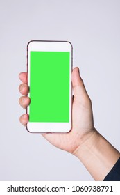 Mobile Phone In Man's Hand With Greenscreen And Path On A White Background