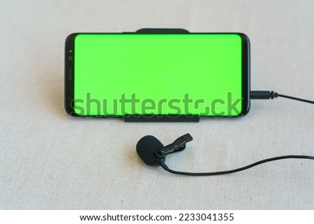 Mobile phone and microphone on table
