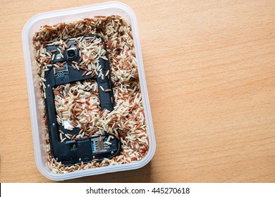 Mobile Phone In Milled Brown Rice. Save Wet Phone.