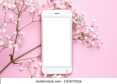 Mobile phone mock up and white flowers on pink pastel table top view in flat lay style. Woman working desk. - Shutterstock ID 1353475016