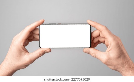 Mobile phone mock-up, horizontal smartphone screen mockup frame in male hands. - Shutterstock ID 2277095029