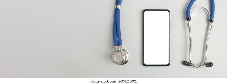 Mobile Phone Mockup For Medical App. Smartphone White Screen Mockup And Stethoscope For Health Application. Banner With Copy Space For Text.