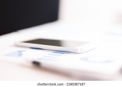 Mobile Phone On A Business Document. Very Shallow Depth Of Field