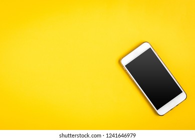 Mobile Phone On Yellow Background.