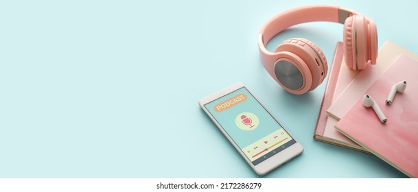 Mobile phone with open podcast playlist, headphones, notebooks and earphones on blue background with space for text