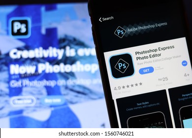 Mobile phone with Photoshop Express Photo Editor icon on screen close up with website on laptop. Blurred background. Los Angeles, California, USA - 9 November 2019, Illustrative Editorial
