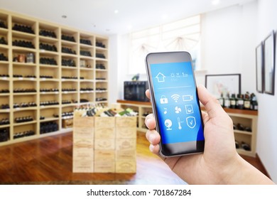 Mobile Phone With Smart Home App In Modern Wine Cellar