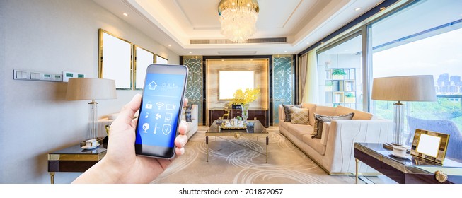 mobile phone with smart home app in modern living room - Shutterstock ID 701872057