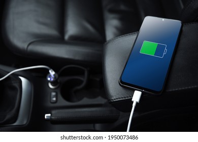 Mobile Phone ,smartphone, Cellphone Is Charged ,charge Battery With Usb Charger In The Inside Of Car. Modern Black Car Interior.