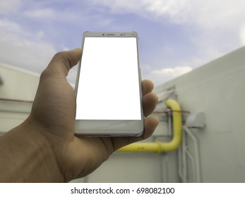 The mobile phone space has background sky 