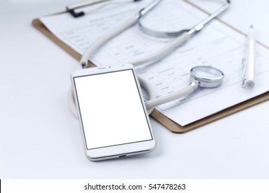 Mobile phone, stethoscope and chart file on the desktop (mobile medical, handheld doctor concepts) - Powered by Shutterstock