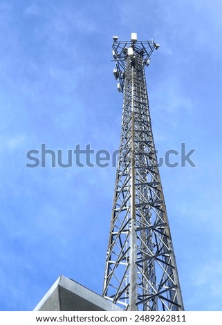 Mobile phone tower with blue sky in the city
