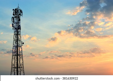 Mobile phone tower silhouette with evening sky.