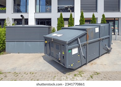 Mobile Press Container Compactor for Reducing Volume of Municipal and Industrial Waste Behind Building - Powered by Shutterstock