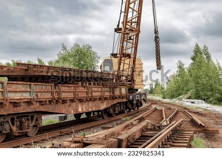 Mobile railway crane on a platform. Replacement and repair of railroad sleepers and other elements. Repair and reconstruction of the railway