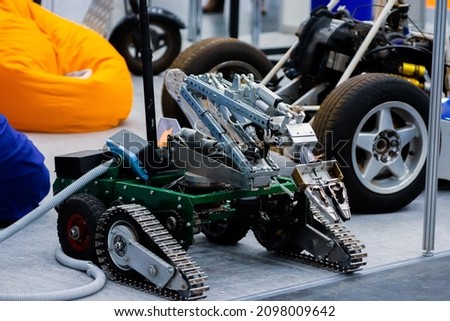 Mobile self-propelled robot. Mobile crawler robot with arm manipulator.