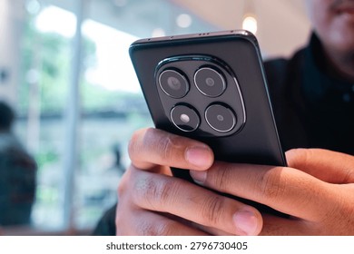 Mobile Technology User Browsing Smartphone in Contemporary Cafe