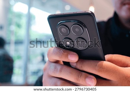 Mobile Technology User Browsing Smartphone in Contemporary Cafe