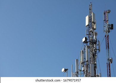 Mobile towers on blue sky background. Many communication equipment.
