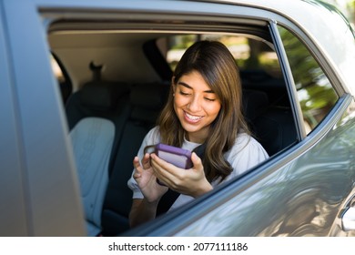 Mobile Transportation App. Beautiful Woman In The Car Texting While Using A Rideshare App On The Smartphone