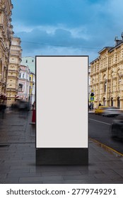 Mobile-friendly vertical composition featuring a blank outdoor billboard on a busy European city street with elegant historic architecture, blurred traffic movement, and dramatic storm clouds. Ideal for advertising, branding, urban marketing, and poster presentation concepts.
