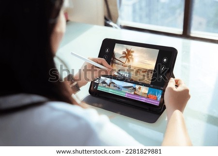 Mobile,Tablet video editng application concept.Female using digital tablet to editing video content
