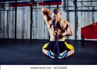 Mobility Exercise - Young Man Stretching Arms With Rubber Band