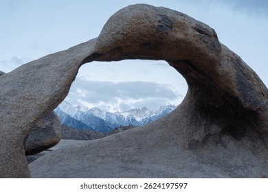 Mobius Arch frames Mount Whitney, the tallest peak in the contiguous United States, as seen from the Mobius Arch Loop Trail in the Alabama Hills near Death Valley, captured May 27, 2019