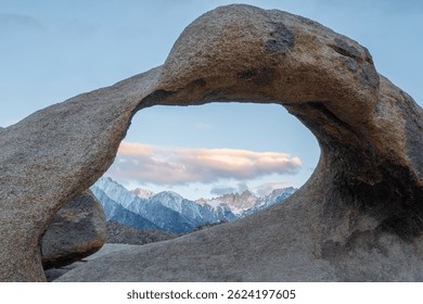 Mobius Arch frames Mount Whitney, the tallest peak in the contiguous United States, as seen from the Mobius Arch Loop Trail in the Alabama Hills near Death Valley, captured May 27, 2019