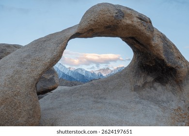 Mobius Arch frames Mount Whitney, the tallest peak in the contiguous United States, as seen from the Mobius Arch Loop Trail in the Alabama Hills near Death Valley, captured May 27, 2019