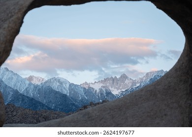 Mobius Arch frames Mount Whitney, the tallest peak in the contiguous United States, as seen from the Mobius Arch Loop Trail in the Alabama Hills near Death Valley, captured May 27, 2019
