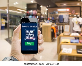 Moblie Wallet Payment With Qr Code Concept.Hands Holding Mobile Phone On  Blurred Clothing Shop In Department Store
As Background