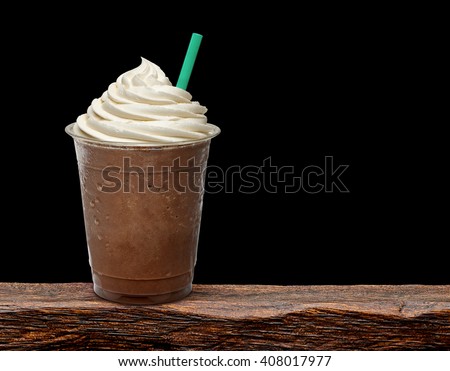 Mocha frappuccino in takeaway cup on wooden table