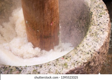 Mochigome glutinous rice being pounded into a thick, malleable, elastic dough for mochi rice cakes during Mochitsuki ceremony at a local household in Shiga prefecture, Japan before the New Year