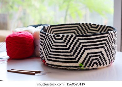 Mochila Wayuu Crochet Bag With Yarn Ball And Wood Crochet Needles With Natural Background. Tapestry Crochet Bag.