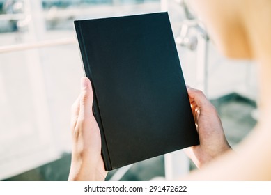 Mock Up Of Black Book Holding Young Woman`s  Hands