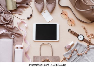 Mock up blank empty digital tablet screen on beige fashion women stylish accessories with tag outfit glamour set flat lay background, online pad computer shopping technology concept, above top view