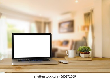 Mock up of blank laptop on the desk. Personal laptop computer on wood table in modern living room. - Powered by Shutterstock