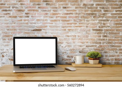 Mock Up Of Blank Laptop On The Desk. Personal Laptop Computer On Wood Table Over Brick Wall Background.