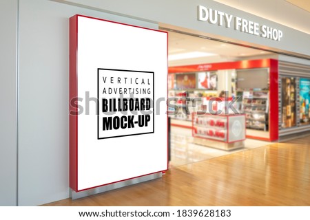 Mock up blank large billboard with clipping path on black metallic wall near entrance to duty free shop at airport terminal, Empty space for insert advertising, announcement, promotion or information 