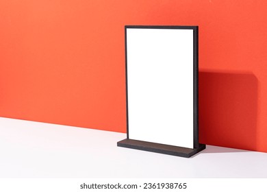 Mock up of blank menu frame, Stand for booklets with white sheets paper on red background with copy space