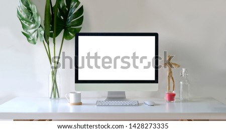 Mock up blank screen computer in stylish workplace